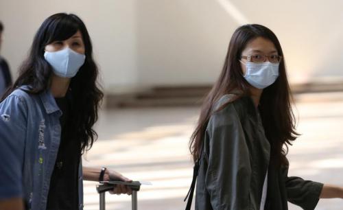 首爾金浦國際機場內的乘客們戴著口罩